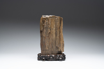 A Chinese petrified wood scholar's rock on wooden stand, 17/18th C.