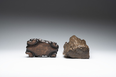 A Chinese petrified wood scholar's rock on wooden stand, 17/18th C.