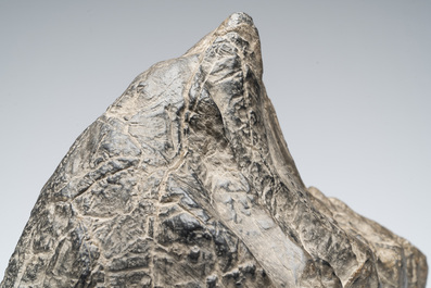A Chinese Lingbi stone scholar's rock on wooden stand, 20th C.