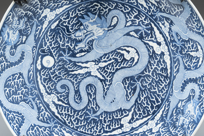 A massive Chinese blue and white reverse-decorated  'dragon' charger with bronze mounts, Chuxiu Gong Zhi mark, Guangxu
