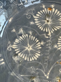 A Chinese Swatow slip-decorated blue-glazed 'chrysanthemum' dish and a turquoise- and black-enamelled 'dragon' dish, Ming