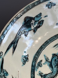 A Chinese Swatow slip-decorated blue-glazed 'chrysanthemum' dish and a turquoise- and black-enamelled 'dragon' dish, Ming