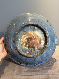 A Chinese Swatow slip-decorated blue-glazed 'chrysanthemum' dish and a turquoise- and black-enamelled 'dragon' dish, Ming