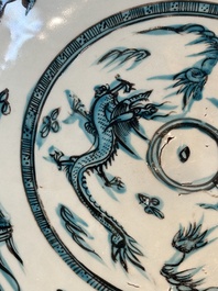 A Chinese Swatow slip-decorated blue-glazed 'chrysanthemum' dish and a turquoise- and black-enamelled 'dragon' dish, Ming