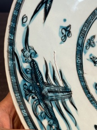 A Chinese Swatow slip-decorated blue-glazed 'chrysanthemum' dish and a turquoise- and black-enamelled 'dragon' dish, Ming