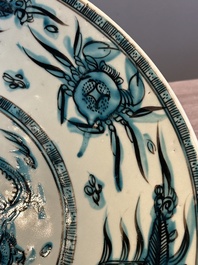 A Chinese Swatow slip-decorated blue-glazed 'chrysanthemum' dish and a turquoise- and black-enamelled 'dragon' dish, Ming