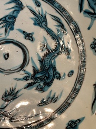 A Chinese Swatow slip-decorated blue-glazed 'chrysanthemum' dish and a turquoise- and black-enamelled 'dragon' dish, Ming
