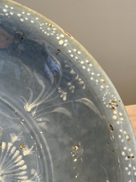 A Chinese Swatow slip-decorated blue-glazed 'chrysanthemum' dish and a turquoise- and black-enamelled 'dragon' dish, Ming