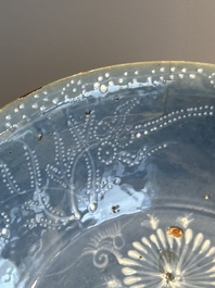 A Chinese Swatow slip-decorated blue-glazed 'chrysanthemum' dish and a turquoise- and black-enamelled 'dragon' dish, Ming