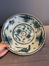 A Chinese Swatow slip-decorated blue-glazed 'chrysanthemum' dish and a turquoise- and black-enamelled 'dragon' dish, Ming