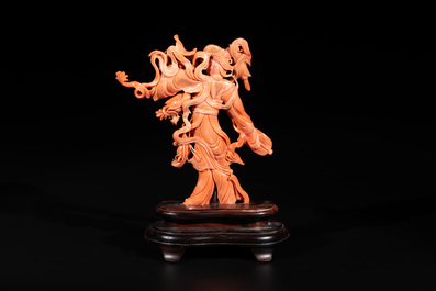 A Chinese red coral Xiwangmu on wooden stand, 19/20th C.