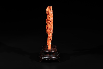 A Chinese red coral Xiwangmu on wooden stand, 19/20th C.