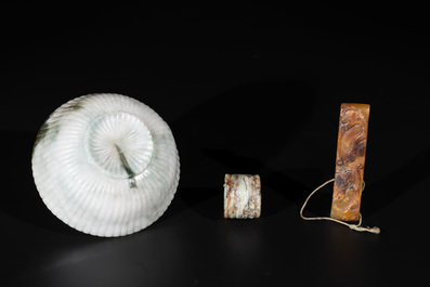 A Chinese jade 'chrysanthemum' bowl, an archer's ring and a belt hook, Ming/Qing