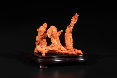 A Chinese red coral 'Sanxing' group on wooden stand, 19/20th C.