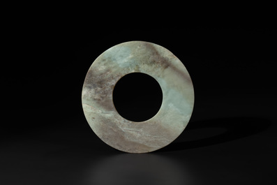 A Chinese celadon and russet jade 'bi' disc, Neolithic period