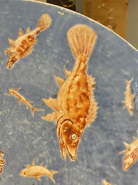 A large Chinese iron-red-decorated blue-ground 'carps' dish, 19th C.