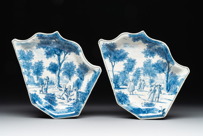 Four fine blue and white Dutch Delft leaf-shaped dishes with travellers in a landscape, early 18th C.