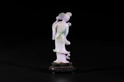 A Chinese lavender- and mint-green-jade figure of a goddess holding a sceptre and fan on wooden stand, 19th C.