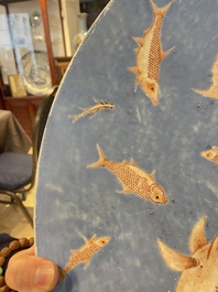 A large Chinese iron-red-decorated blue-ground 'carps' dish, 19th C.