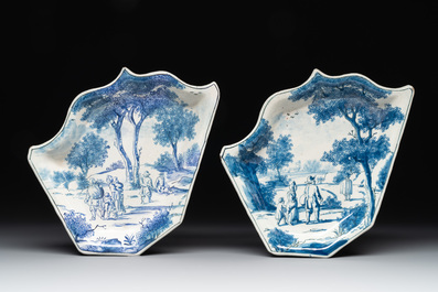 Four fine blue and white Dutch Delft leaf-shaped dishes with travellers in a landscape, early 18th C.
