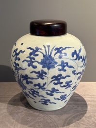 A Chinese blue and white 'lotus scroll' vase with wooden cover, Kangxi