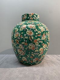 A pair of Chinese famille verte green-ground 'prunus' jars and covers, 19th C.
