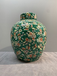 A pair of Chinese famille verte green-ground 'prunus' jars and covers, 19th C.