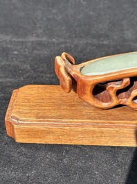 A Chinese pale celadon jade 'double happiness' hairpin on a ruyi-shaped wooden stand, 19th C.