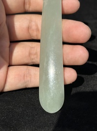 A Chinese pale celadon jade 'double happiness' hairpin on a ruyi-shaped wooden stand, 19th C.