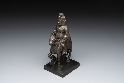 A rare Chinese bronze Vaishravana on horseback with wooden stand, Yuan