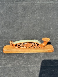 A Chinese pale celadon jade 'double happiness' hairpin on a ruyi-shaped wooden stand, 19th C.