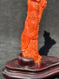 Two Chinese red coral figures of Shoulao on wooden stand, 19/20th C.