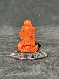 A Chinese carved red coral 'dragon' snuff bottle on wooden stand, 19/20th C.