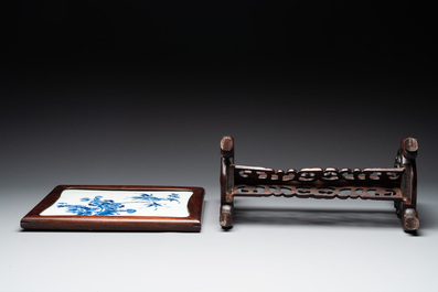 A Chinese blue and white plaque with floral design in a carved wooden screen, 19/20th C.