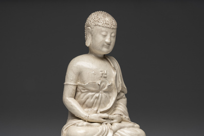An extremely rare Chinese Swatow cream-glazed seated Buddha, Xuande mark, Ming