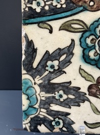 A Syrian Damascus Iznik-style tile with grape and flower scrolls, early 17th C.