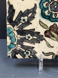 A Syrian Damascus Iznik-style tile with grape and flower scrolls, early 17th C.