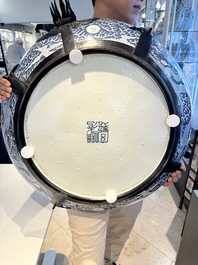 A massive Chinese blue and white reverse-decorated  'dragon' charger with bronze mounts, Chuxiu Gong Zhi mark, Guangxu