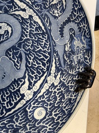 A massive Chinese blue and white reverse-decorated  'dragon' charger with bronze mounts, Chuxiu Gong Zhi mark, Guangxu