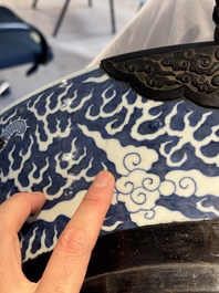 A massive Chinese blue and white reverse-decorated  'dragon' charger with bronze mounts, Chuxiu Gong Zhi mark, Guangxu