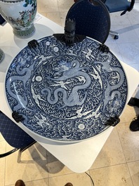 A massive Chinese blue and white reverse-decorated  'dragon' charger with bronze mounts, Chuxiu Gong Zhi mark, Guangxu