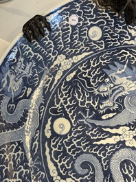 A massive Chinese blue and white reverse-decorated  'dragon' charger with bronze mounts, Chuxiu Gong Zhi mark, Guangxu