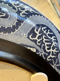 A massive Chinese blue and white reverse-decorated  'dragon' charger with bronze mounts, Chuxiu Gong Zhi mark, Guangxu