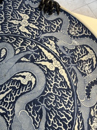 A massive Chinese blue and white reverse-decorated  'dragon' charger with bronze mounts, Chuxiu Gong Zhi mark, Guangxu