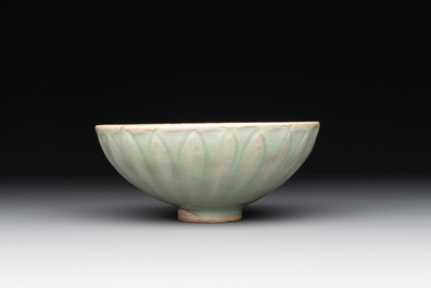 A Chinese Longquan celadon 'lotus' bowl and a large green-glazed jar, Ming and later