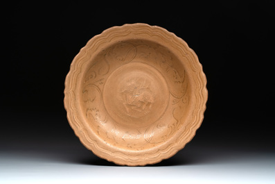 A Chinese Longquan celadon plate and two saucer dishes, Ming