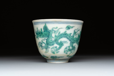 A Chinese gilt-decorated blue and white 'lotus scroll' square bowl, a saucer and a doucai 'dragon' cup, Daoguang mark and of the period