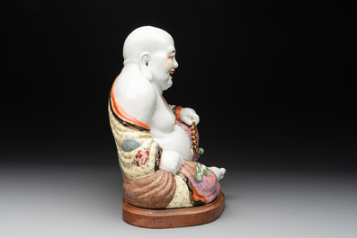 A large Chinese famille rose Milefo Buddha on wooden stand, 20th C.