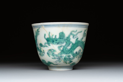 A Chinese gilt-decorated blue and white 'lotus scroll' square bowl, a saucer and a doucai 'dragon' cup, Daoguang mark and of the period