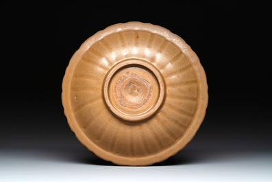 A Chinese Longquan celadon plate and two saucer dishes, Ming